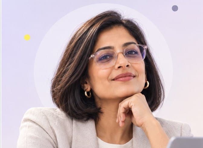 Professional woman with glasses at a laptop, smiling